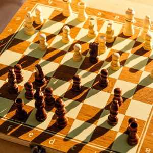 a wooden chess board with chess pieces on it